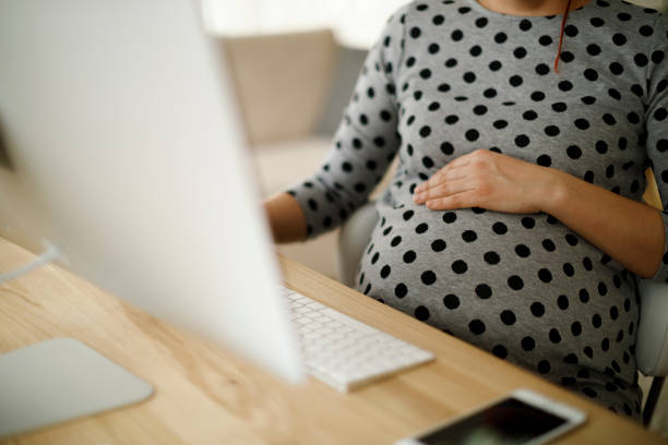 Pregnant woman working from home office